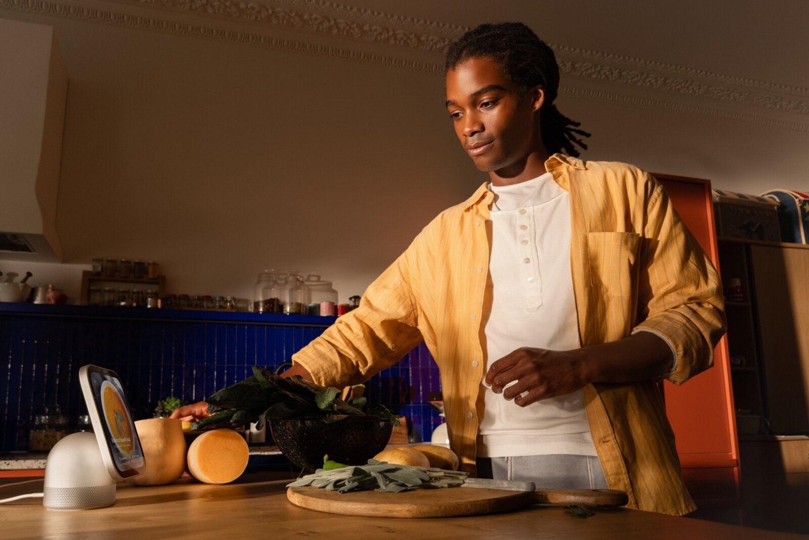 A man cooking with vegetables next to a HomeView showing a soup recipe