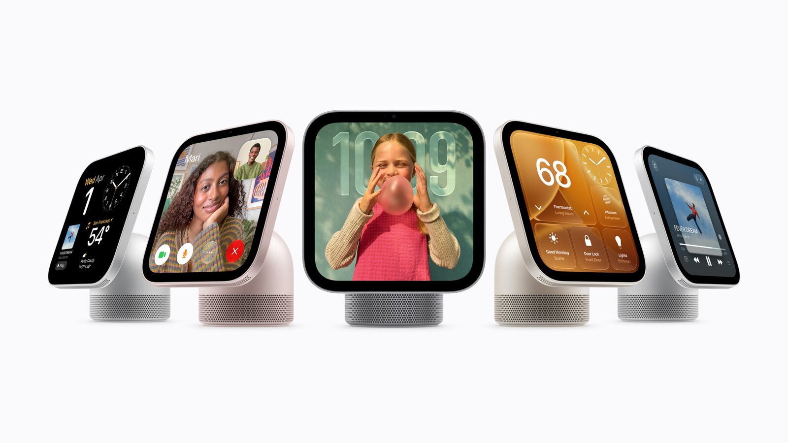 Five tabletop HomeView devices showing a clock, a FaceTime call, a photo, home controls and music